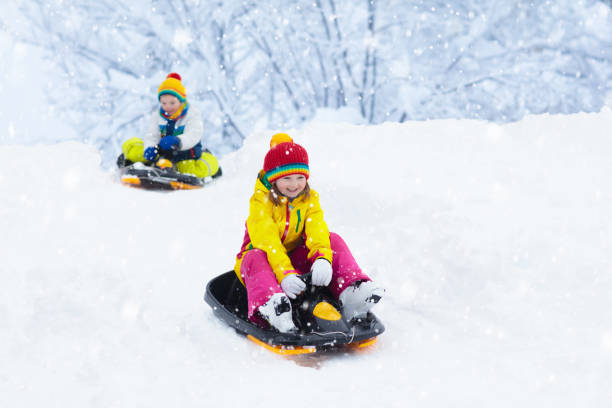 istock Girl on sled ride. Child sledding. Kid on sledge 1068864262