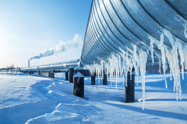 Winter landscape with icicles on the gas pipeline Gas pipe going to the city boiler icicle photos stock pictures, royalty-free photos & images