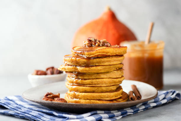 istock Pumpkin spice pancakes with pecan nuts and caramel sauce 1068871880