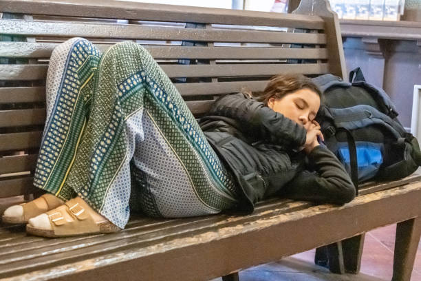 young traveler sleeping at the station bench