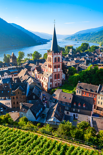 Dinant Cityscape at the waterfront of River Meuse under blue summer sky.  Famous Notre Dame de Dinant Collegial church - Collégiale Notre Dame de Dinant - Church of Our Lady from the 13th-century, old gothic cathedral and huge chalk cliff behind the Town of Dinant. 102 MPixel Hasselblad X2D Cityscape. Dinant, Wallonia, Namur, Belgium, Europe.