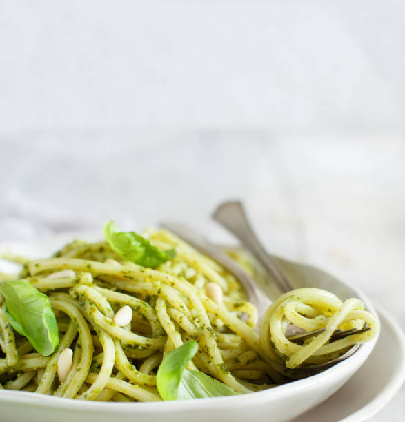 istock Spaghetti pasta with pesto sauce 1068876156