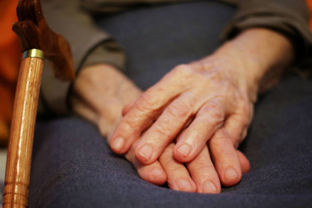 istock Old woman hands with cane 1068878948