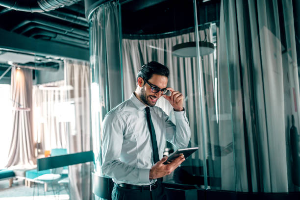 istock Handsome businessman at office looking at tablet. 1068878970
