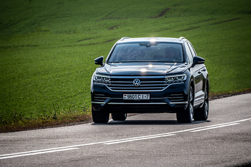 Minsk, Belarus - October 2, 2018: Third generation of Volkswagen Touareg drives along a narrow road during test drive.