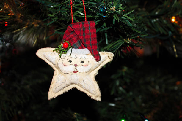 istock Handmade Fabric Santa Star Ornament hanging on a Christmas Tree 1068888182