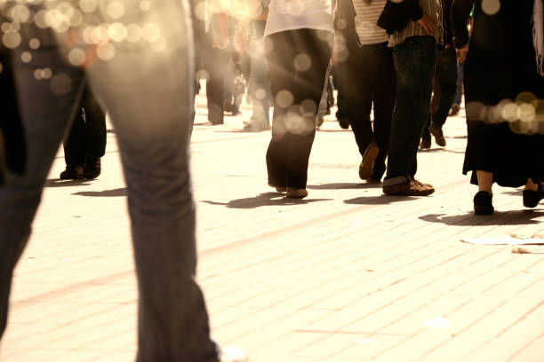 istock crowded people walking on busy street 1068890360