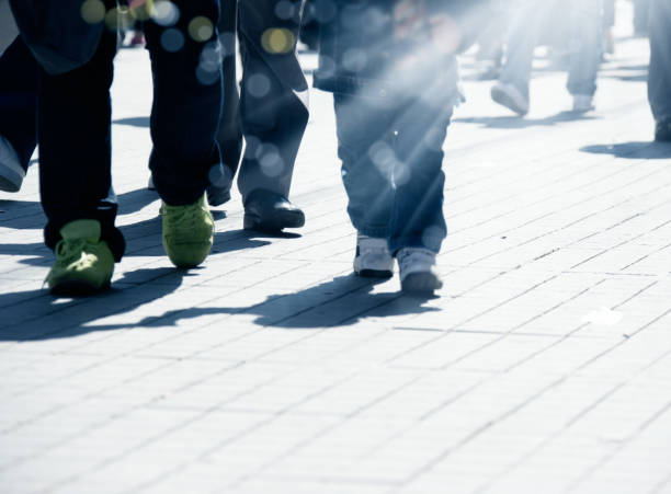 istock crowded people walking on busy street 1068890412