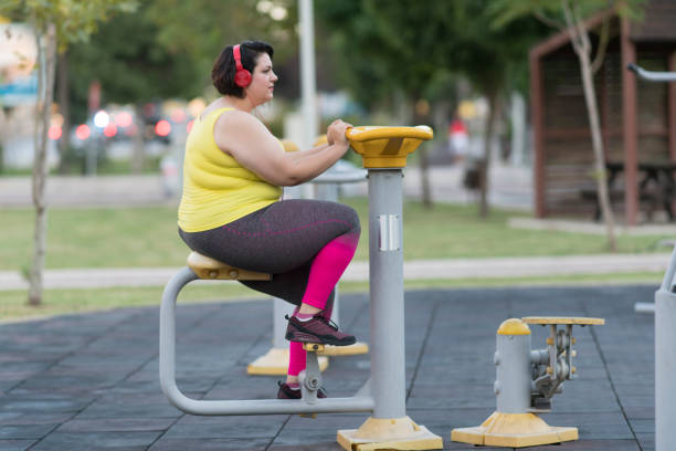 istock Oversized woman exercising in the park 1068891206