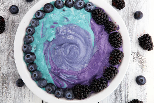 Healthy breakfast. smoothie bowl with blackberries and granola on rustic background