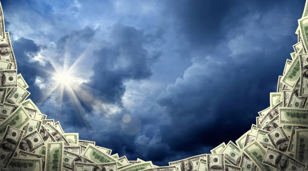 istock American one hundred dollar bill pile over cloudy sky 1068895296
