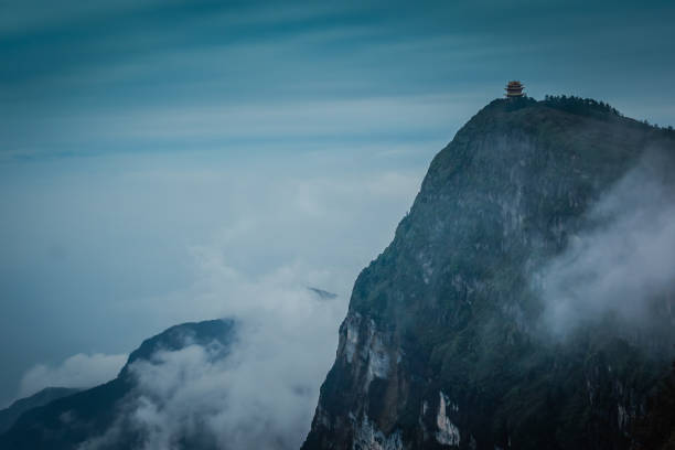 Photographed on top of Emei Mountain in Sichuan province, China, one of the four sacred Buddhist peaks in China famous for fog. At over 10,000 feet, this temple was showing itself majestically from behind the clouds and fog