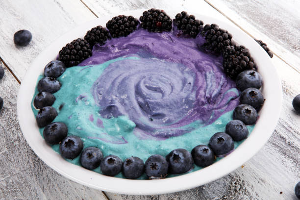 Healthy breakfast. smoothie bowl with blackberries and granola on rustic background
