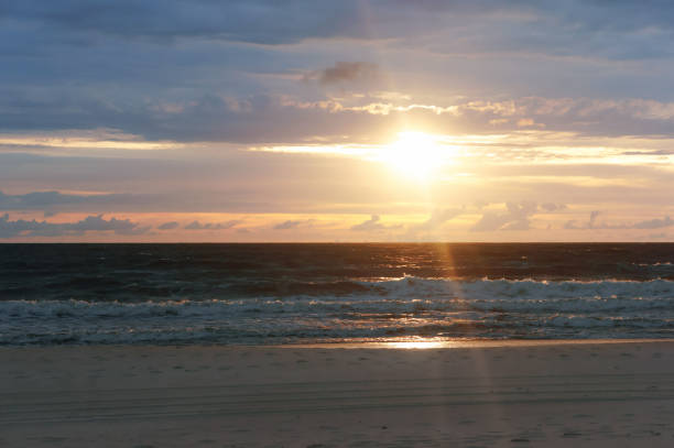 istock beautiful sunrise and waves on the sea 1068901208