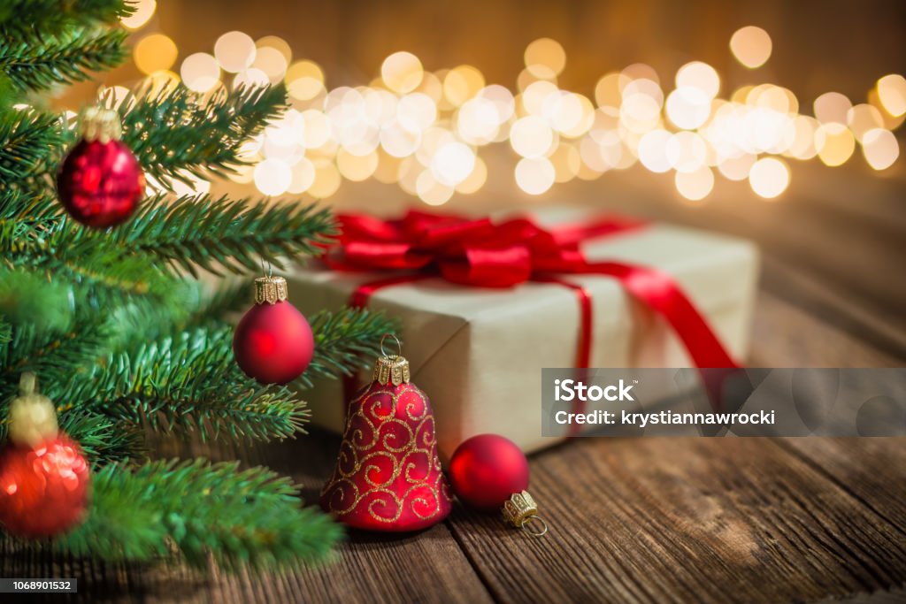 Red Christmas Ornaments and Gift on Wood Background with defocused lights sparkles Red Christmas tree decorated with Ornaments and Gift on Wood Background with defocused lights sparkles Christmas Tree Stock Photo