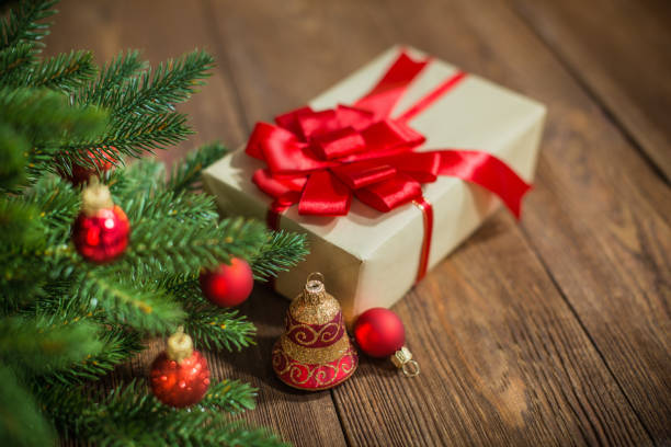 istock Red Christmas Ornaments and Gift on Wood Background 1068901564