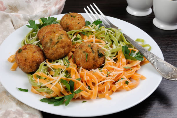Spaghetti from carrots and spinach with chicken meatballs flavored cheese Parmesan, herb stock photo