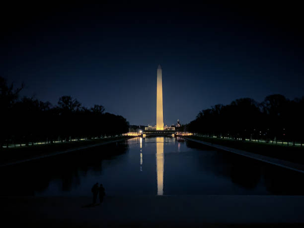 Washington Monument obelisk illuminated at night in Washington D.C. stock photo