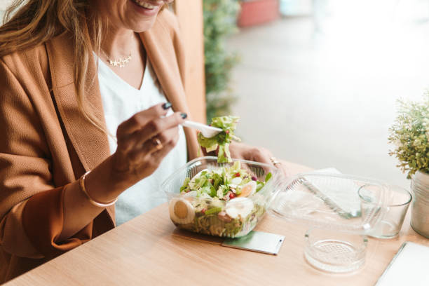 istock Happy woman eating lunch at a restaurant 1068903624