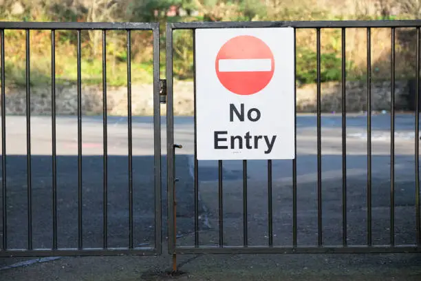 School no entry sign at entrance gate for the public to keep pupils safe uk