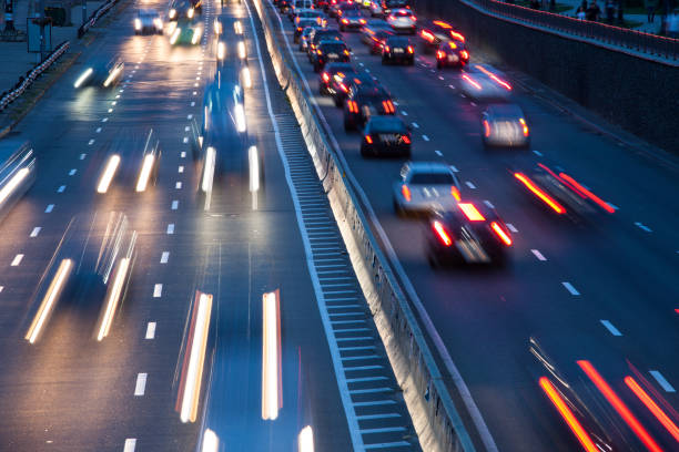 istock Car traffic light at night city. Modern highway traffic view 1068915626