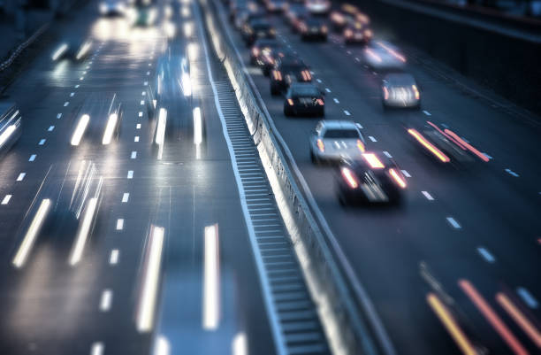 istock Car traffic light at night city. Modern highway traffic view 1068915638