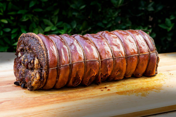 istock Whole Cooked roasted rolled pork on chopping board 1068916388