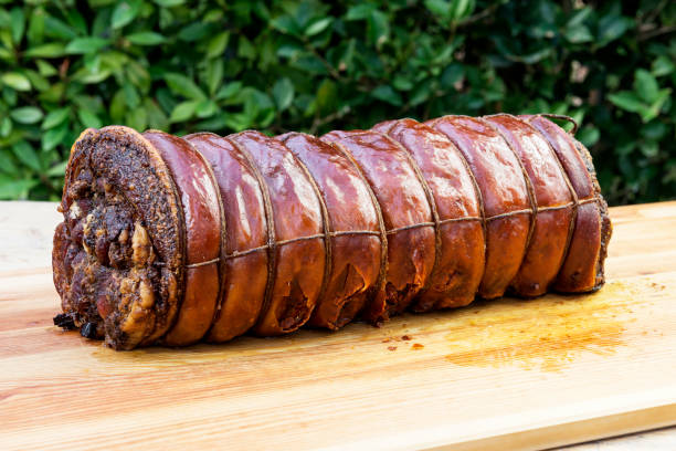istock Whole Cooked roasted rolled pork on chopping board 1068916424