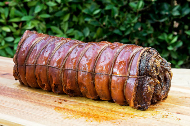 istock Whole Cooked roasted rolled pork on chopping board 1068916502