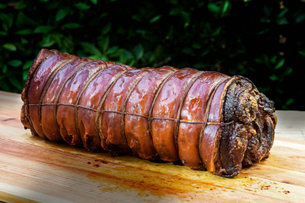 istock Whole Cooked roasted rolled pork on chopping board 1068916682