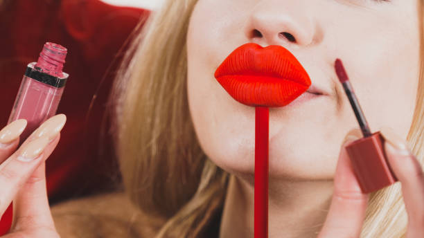 istock Woman applying lipstick or lip gloss 1068931478
