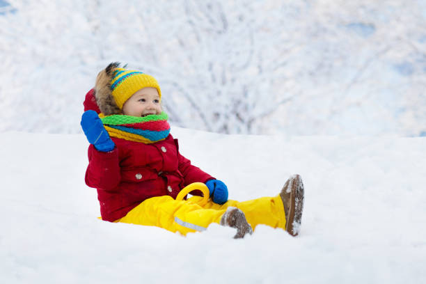 istock Baby on sled ride. Child sledding. Kid on sledge 1068936710