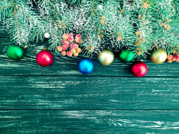 istock Christmas tree branch on a wooden snow background 1068936920
