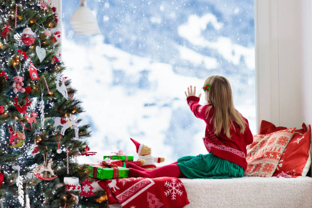 istock Kids at Christmas tree. Children drink hot cocoa 1068936936