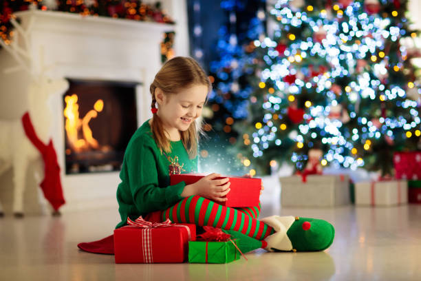 istock Kids at Christmas tree. Children open presents 1068937614