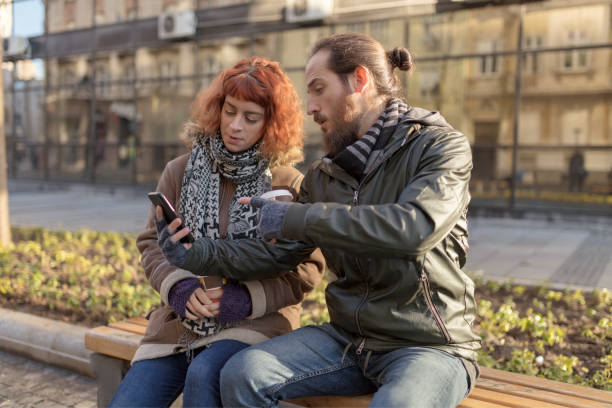 istock Young couple looking at smartphone 1068950026