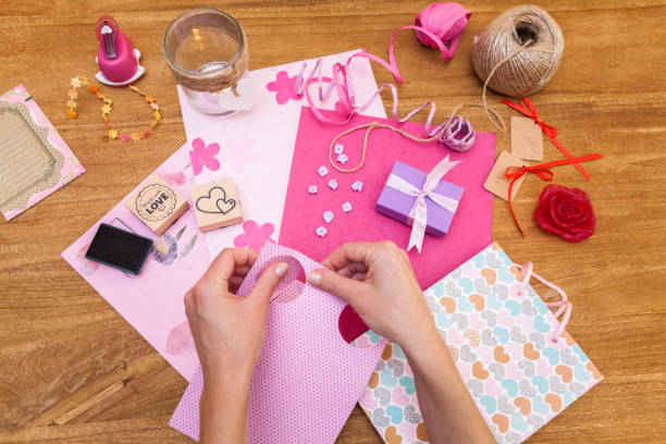 istock Packing a gift on a wooden table for a festive occasion 1068954576