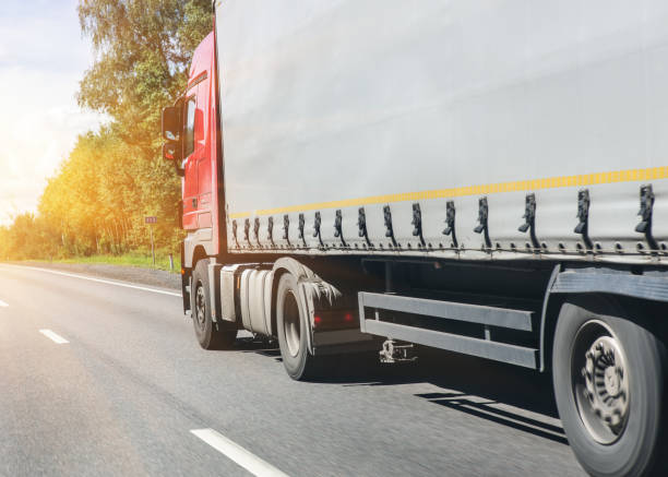 istock truck goes on the highway 1068957058