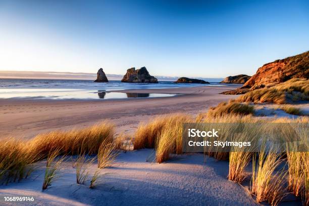 Landscape Image Of Sunset At Coastline In New Zealand Stock Photo - Download Image Now