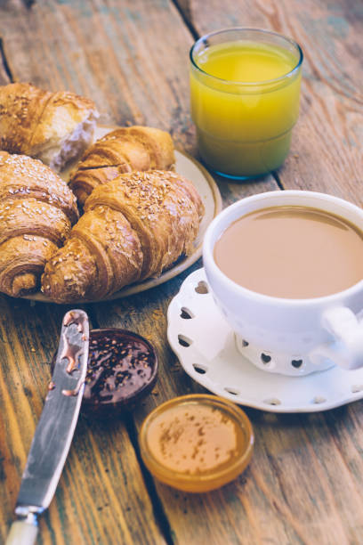 istock Black coffee and croissant with jam. Typical French Breakfast (Petit DÃ©jeuner) background. 1068972406