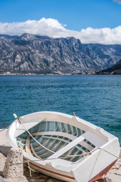 istock Small fishing boat on the shore in Perast 1068974832