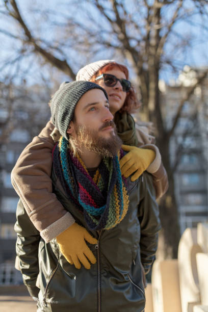istock Young man carrying girlfriend in the park 1068976590