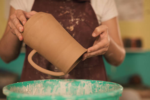 istock Pottery artist making a shape from clay 1068976716