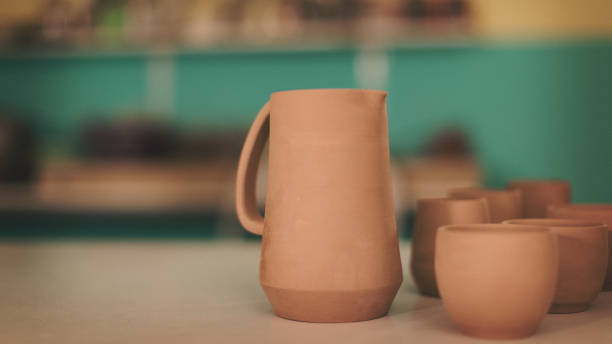 Pottery artist making a shape from clay. Shallow DOF. Developed from RAW; retouched with special care and attention; Small amount of grain added for best final impression. 16 bit Adobe RGB color profile.