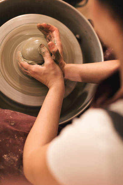 istock Pottery artist making a shape from clay 1068980400