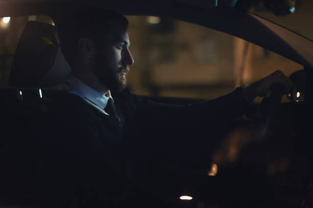 istock Businessman working late and driving a car 1068982724