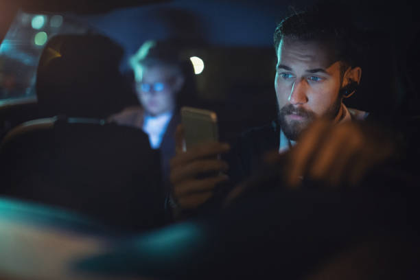 istock Businessman working late and driving a car 1068982814