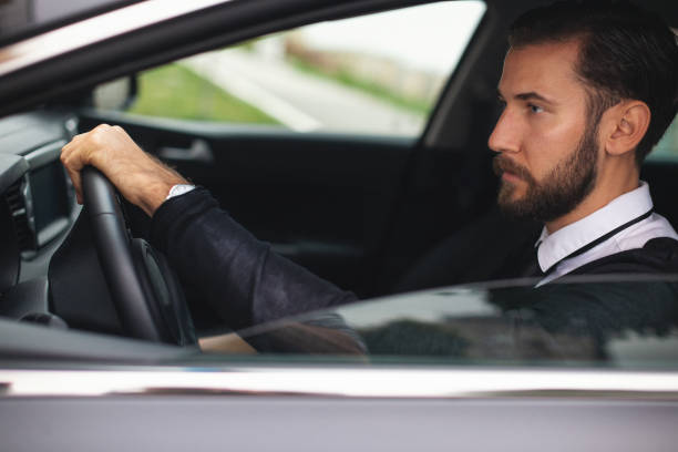 istock Businessman driving a car 1068995424
