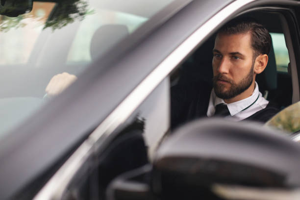istock Businessman driving a car 1068995728