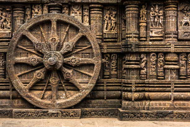 Carved chariot wheel on Konark Sun Temple, Odisha, India The temple complex , all carved from stone, has the appearance of a chariot with immense wheels and horses and was declared Unesco heritage site chariot wheel at konark sun temple india stock pictures, royalty-free photos & images